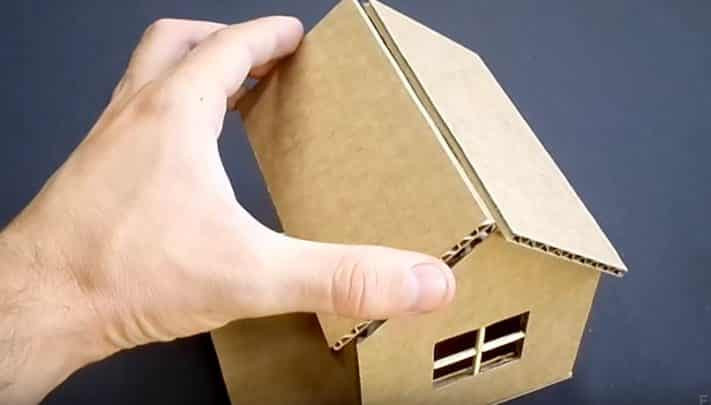 Dán tấm bìa carton để lợp mái cho ngôi nhà bằng giấy đơn giản đang được tạo hình