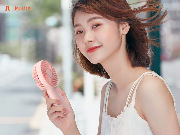 Người dùng đang tìm hiểu cách sử dụng quạt cầm tay Jisulife để làm mát hiệu quả trong thời tiết nắng nóng.