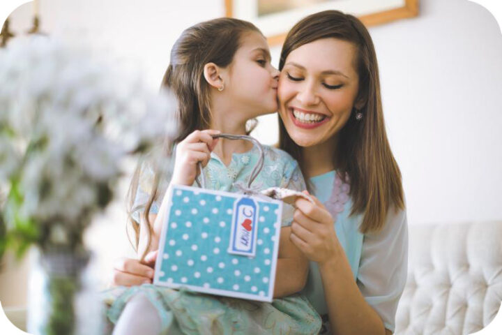 Người mẹ cõng con trên lưng, cả hai cùng mỉm cười rạng rỡ