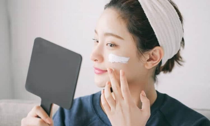 Người phụ nữ dùng bông tẩy trang
